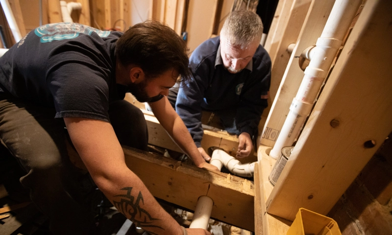 plumbers working on pipes 