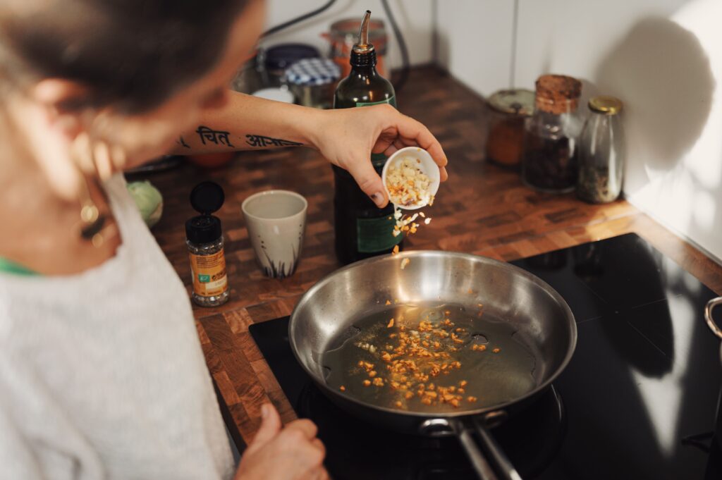 person cooking on electric stovetop 