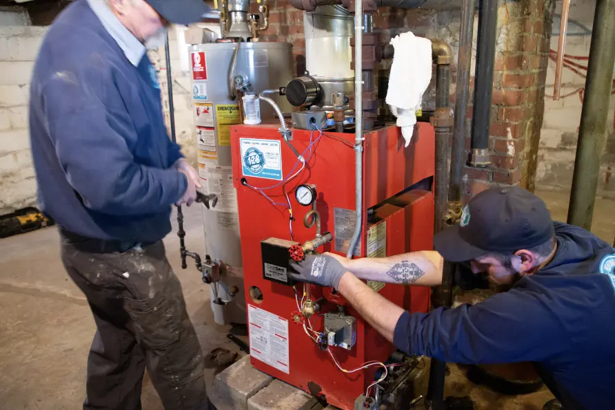 technicians working on heating system
