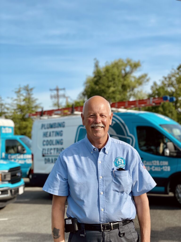 128 technician with trucks in the background