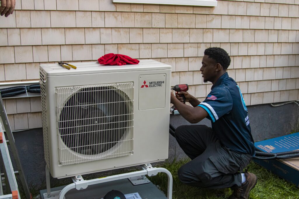 128 technicians installing a mitsubishi condenser at a home 