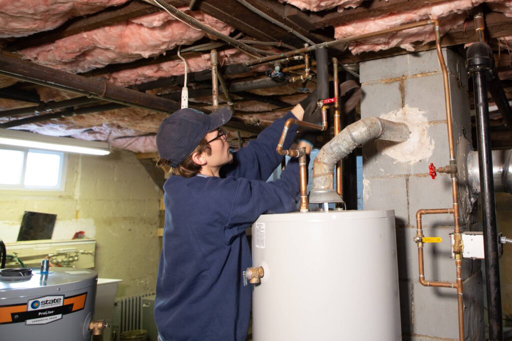 plumber working on boiler pipes 