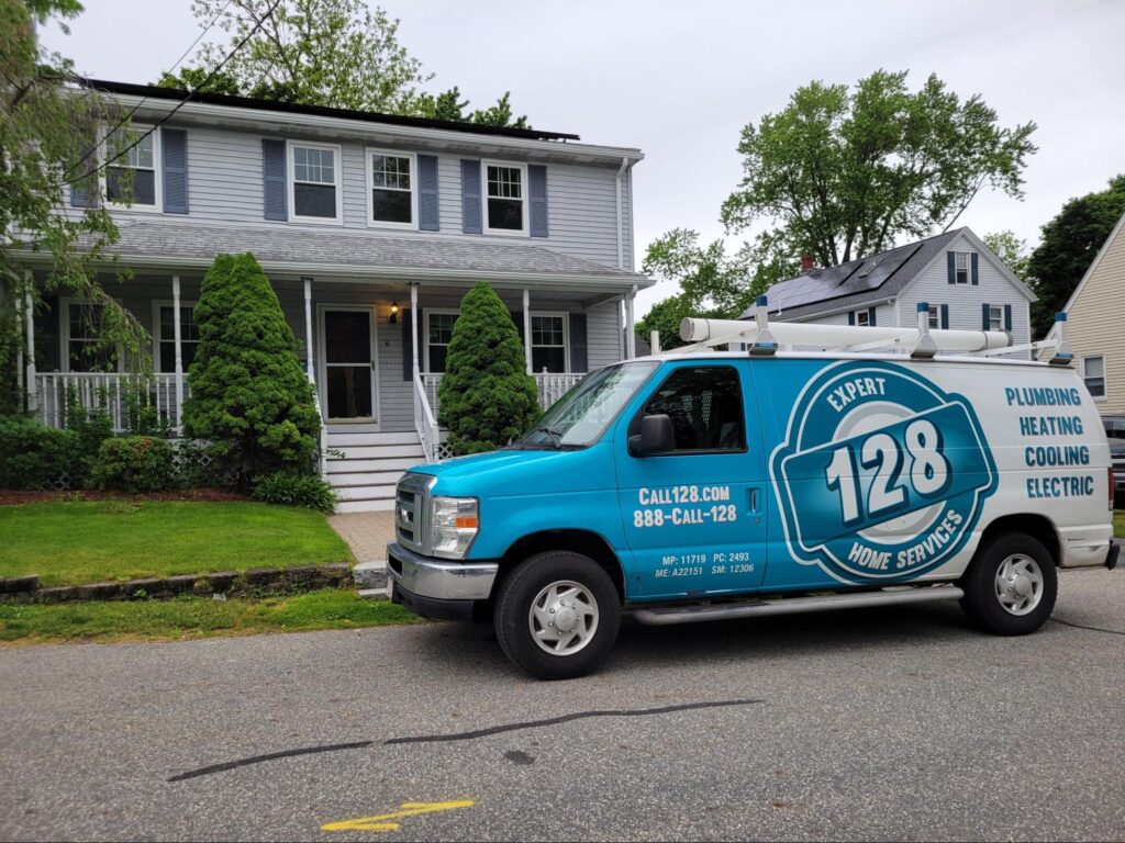 128plumbing's van parked in front of a house