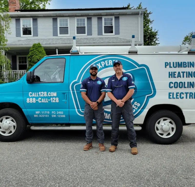 two men standing in front of a 128plumbing's van. Mass Save