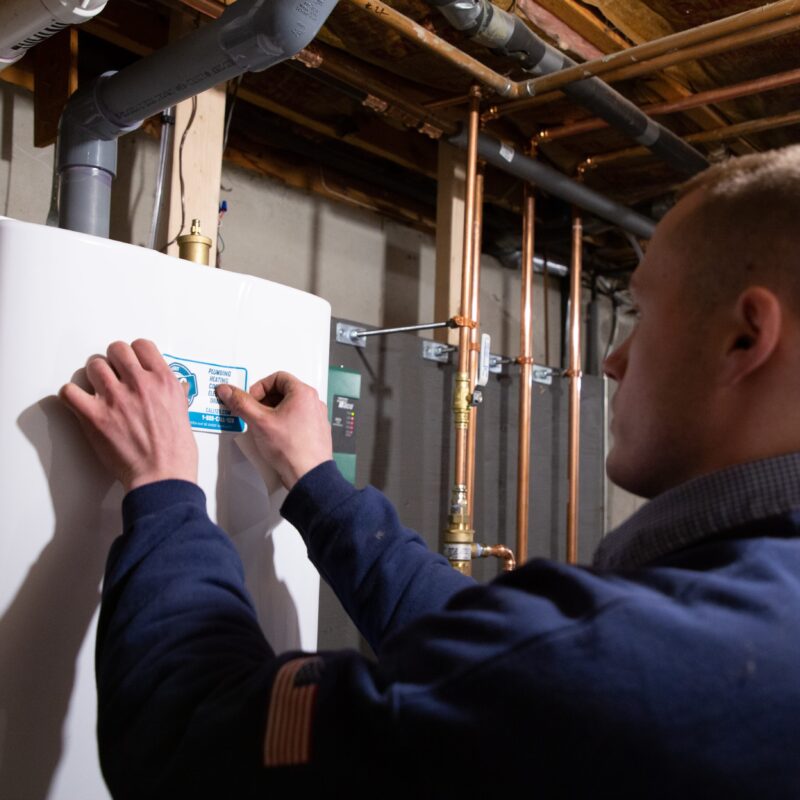 tech putting sticker on unit