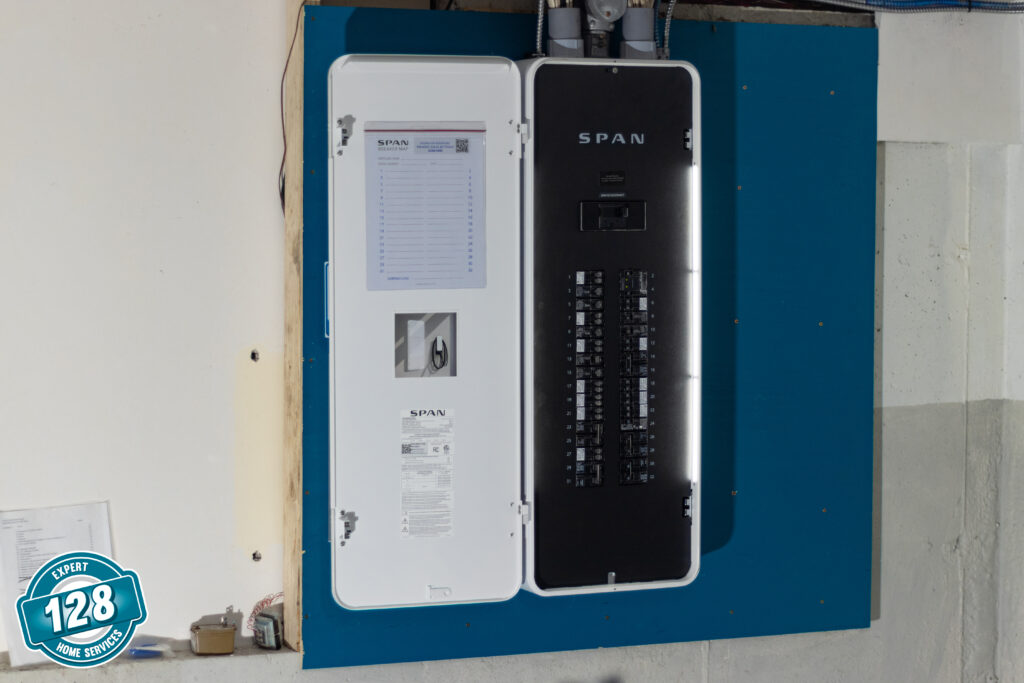 Electrical circuit breaker panel mounted on a blue wall with a span logo, including labels and switches visible.