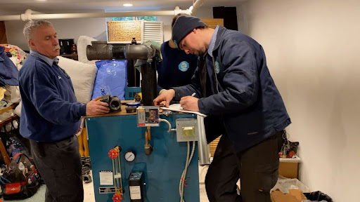 technicians speaking to one another with hvac parts 