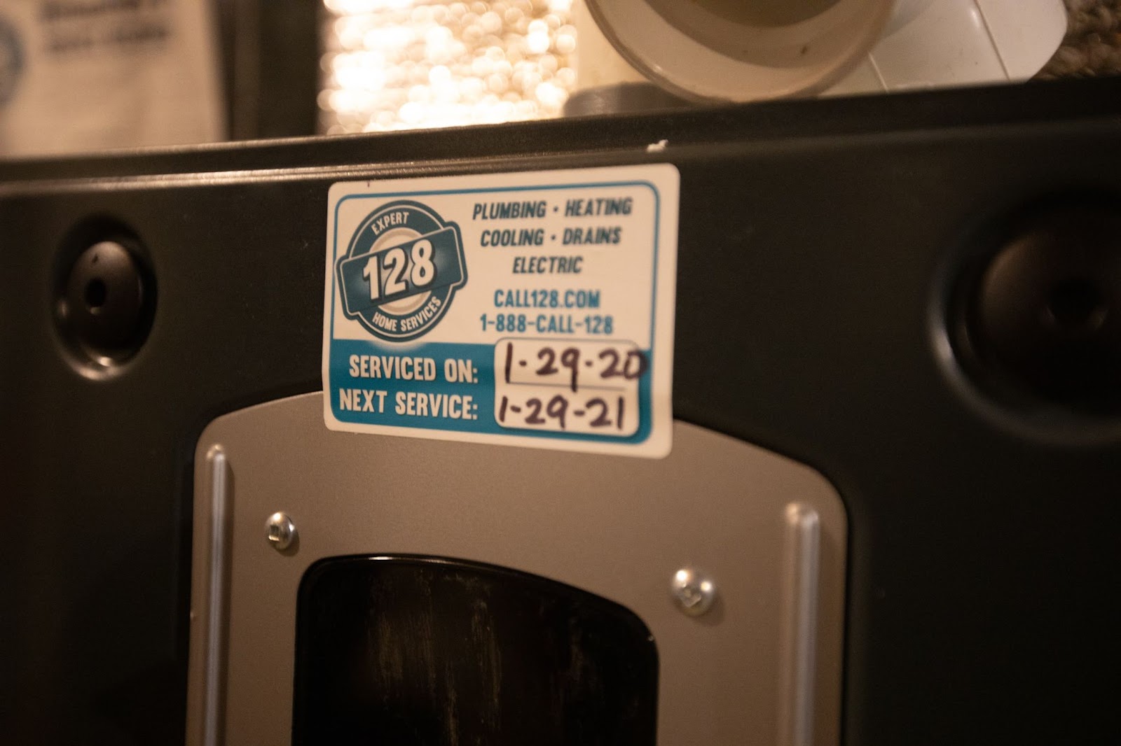 Sticker on the device from an HVAC company in Canton, MA, indicates service dates: "Serviced on: 1-29-20" and "Next service: 1-29-21.
