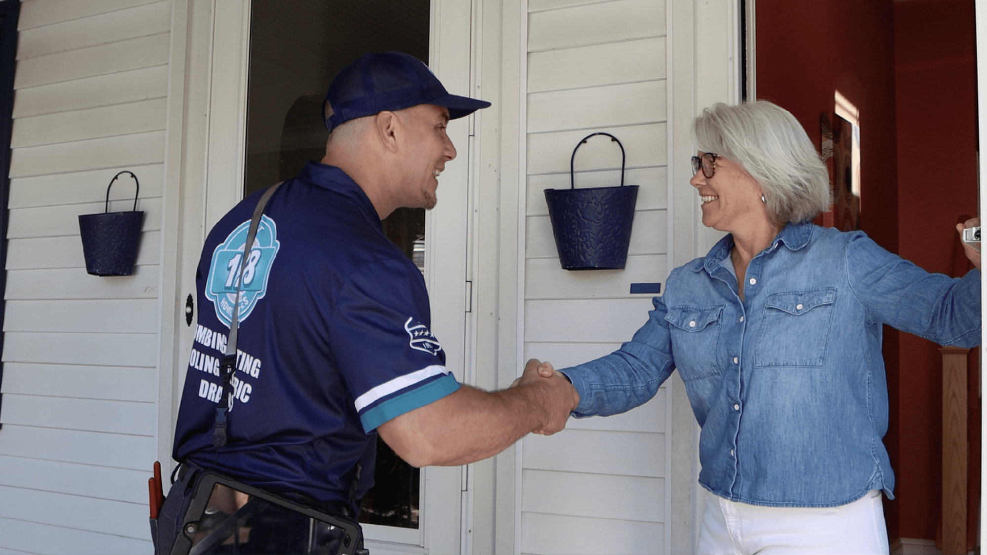 128 employee shaking hand of happy home owner after doing an air conditioning service in newton ma.