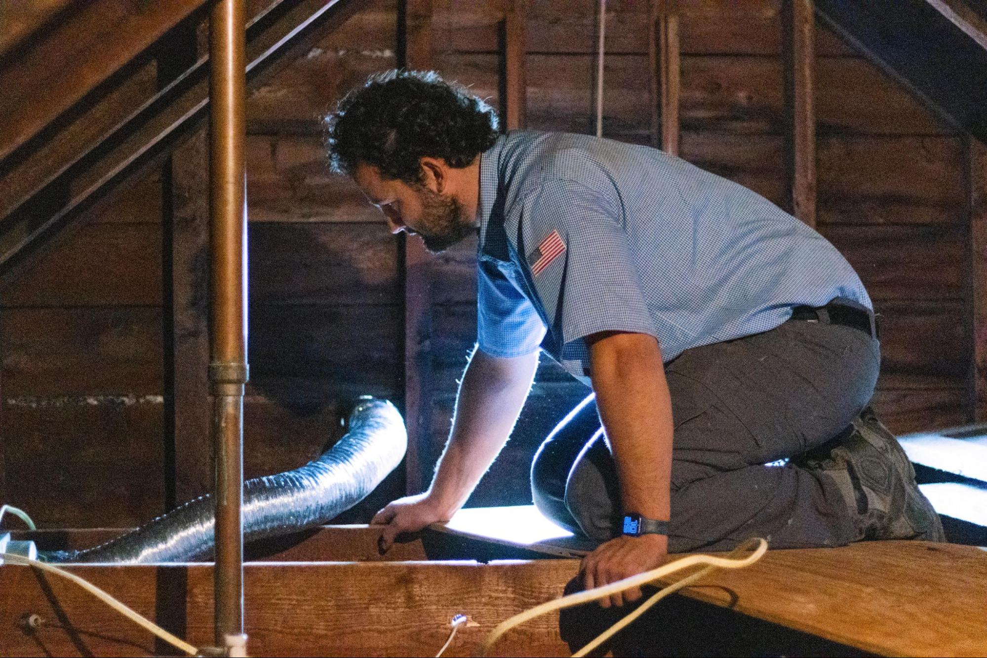 An 128 electrician in newton MA doing a service in the attic