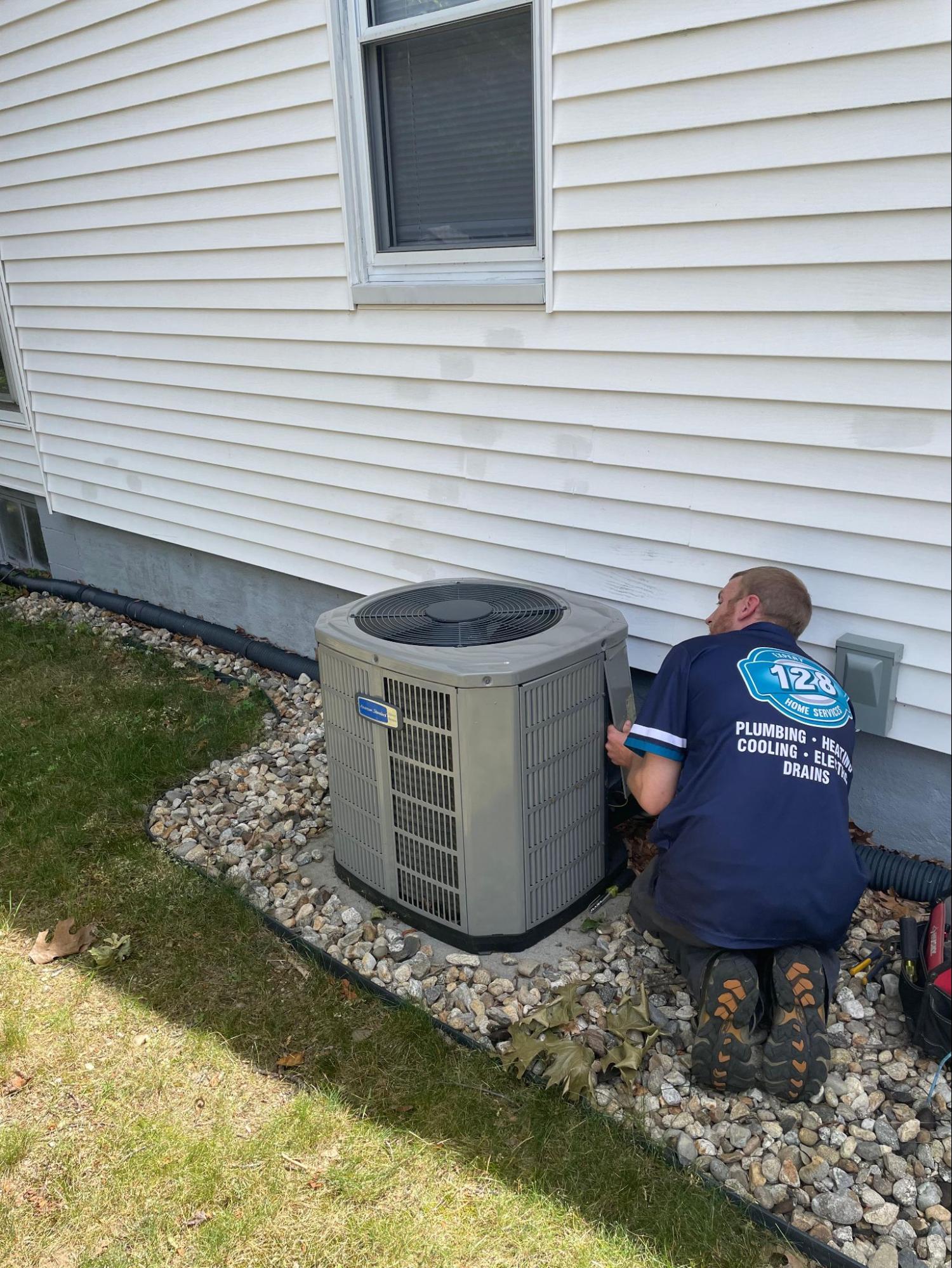 128 Plumbing technician working in outdoor air conditioning in winchester MA