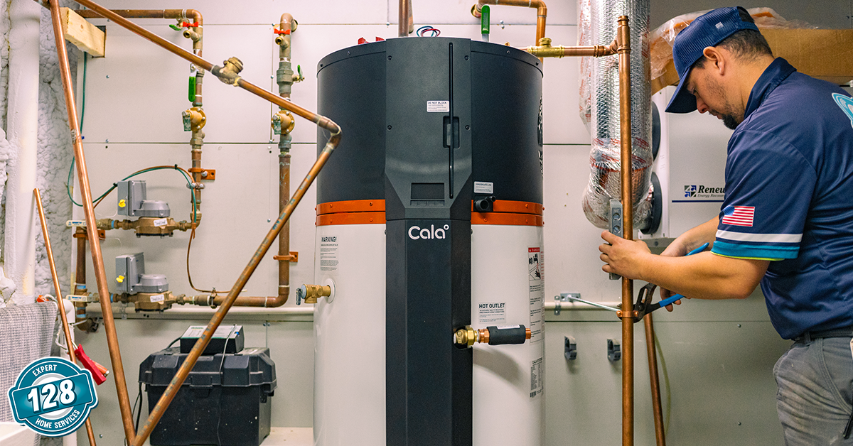 A technician in uniform works on copper pipes next to a large water heater in a utility room with various plumbing equipment.