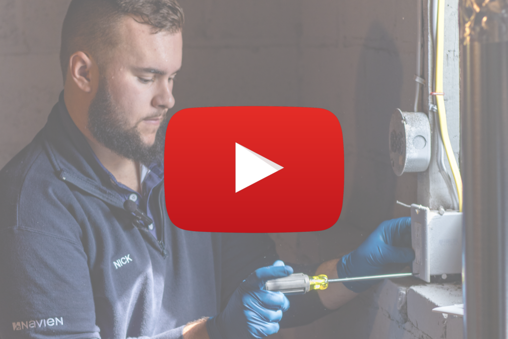 A person in blue gloves uses a screwdriver on an electrical panel near a window; a large YouTube play button is overlaid on the image.