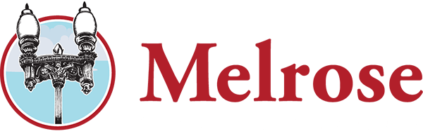 Logo for the Melrose Chamber of Commerce featuring a vintage streetlamp illustration next to the word "Melrose" in large red letters.